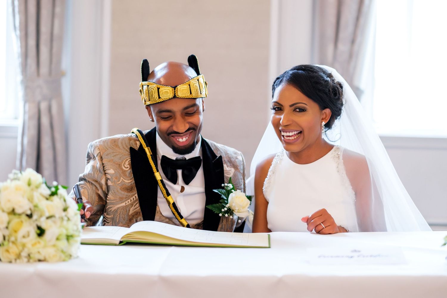 A joyous wedding reception with guests celebrating and dancing in an elegant indoor venue.