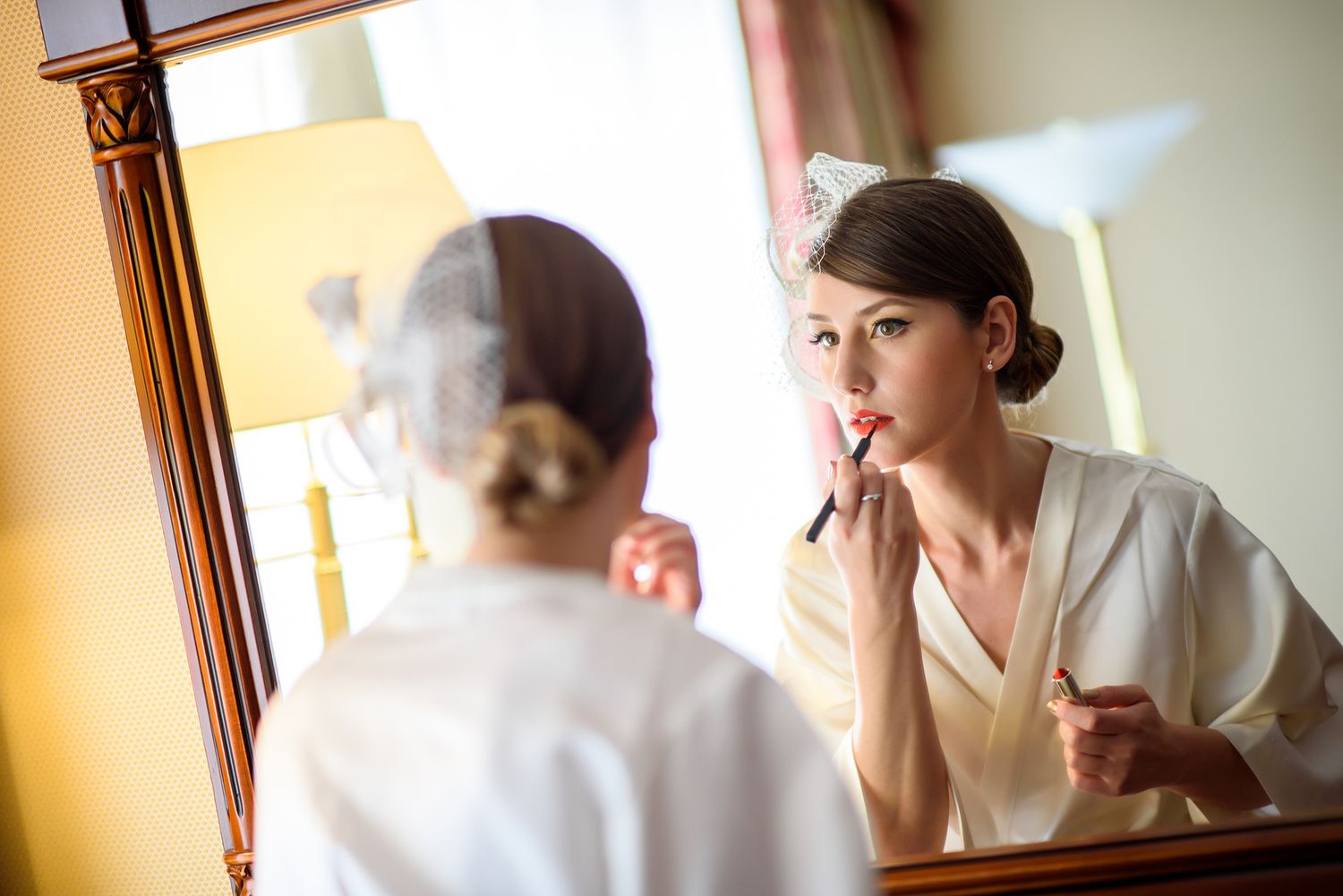 Wedding preparation scene with soft morning light streaming through windows.