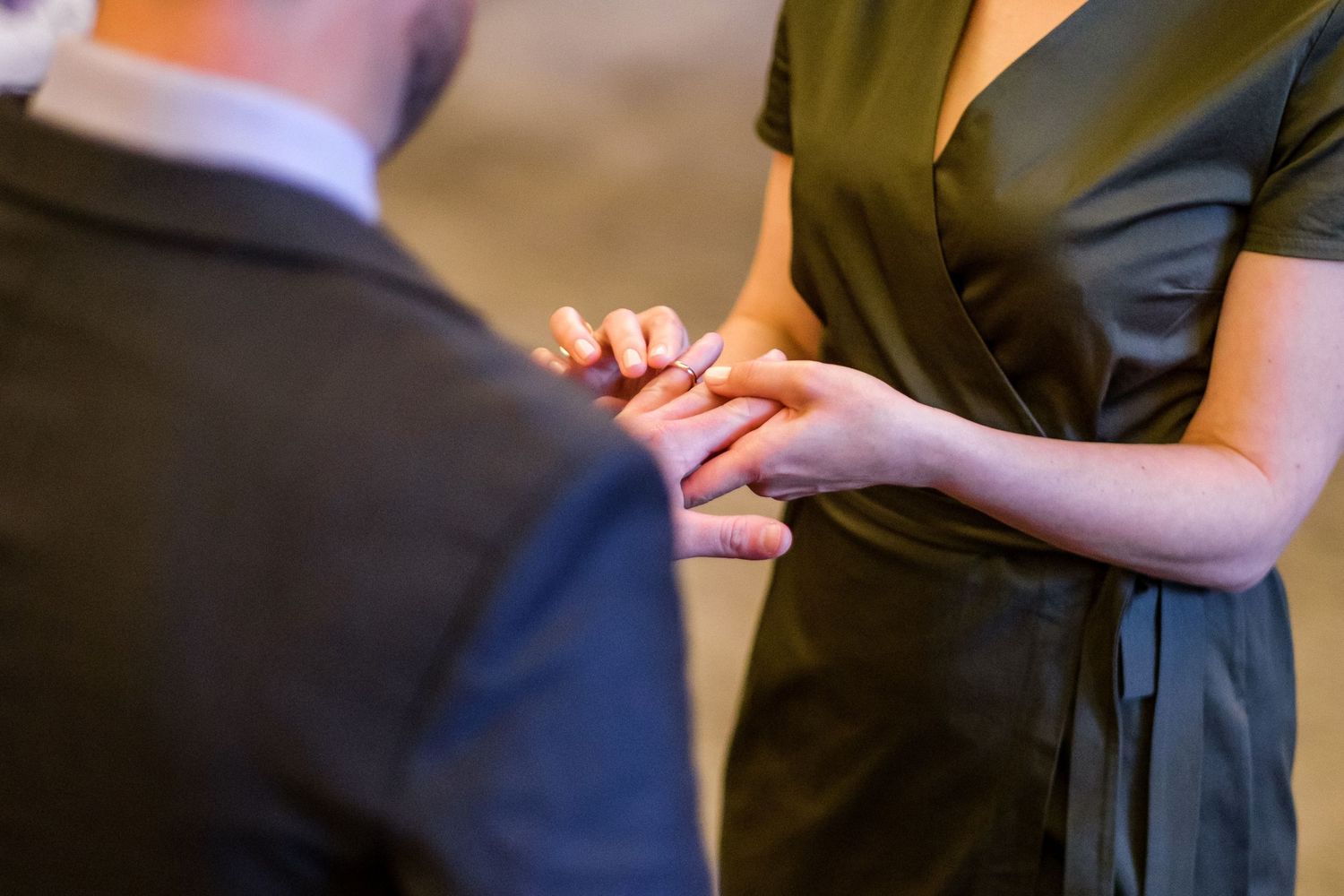 A couple shares an intimate moment during a wedding dance, with the groom dipping his partner on the dance floor.
