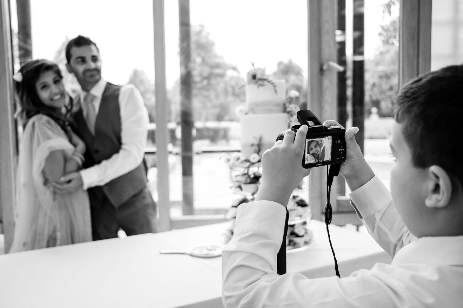Wedding guests enjoying themselves and taking photos during an outdoor celebration.