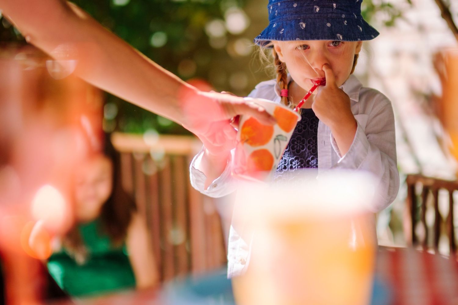 Couple laughing and blowing bubbles together during a joyful outdoor photo session.
