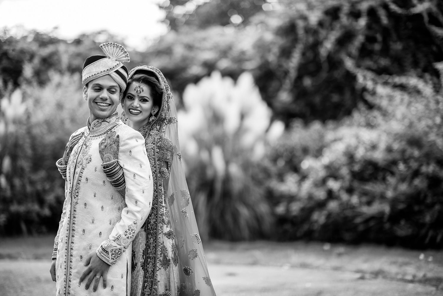 Black and white outdoor portrait session in a natural garden setting.