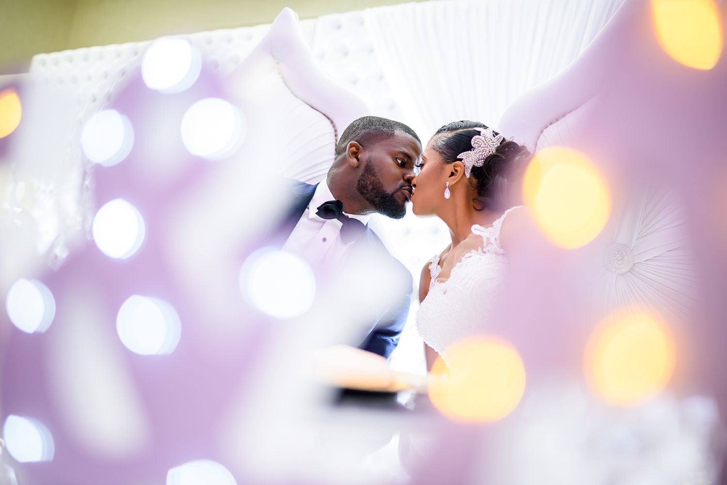 Romantic wedding scene with soft purple bokeh lighting effects.