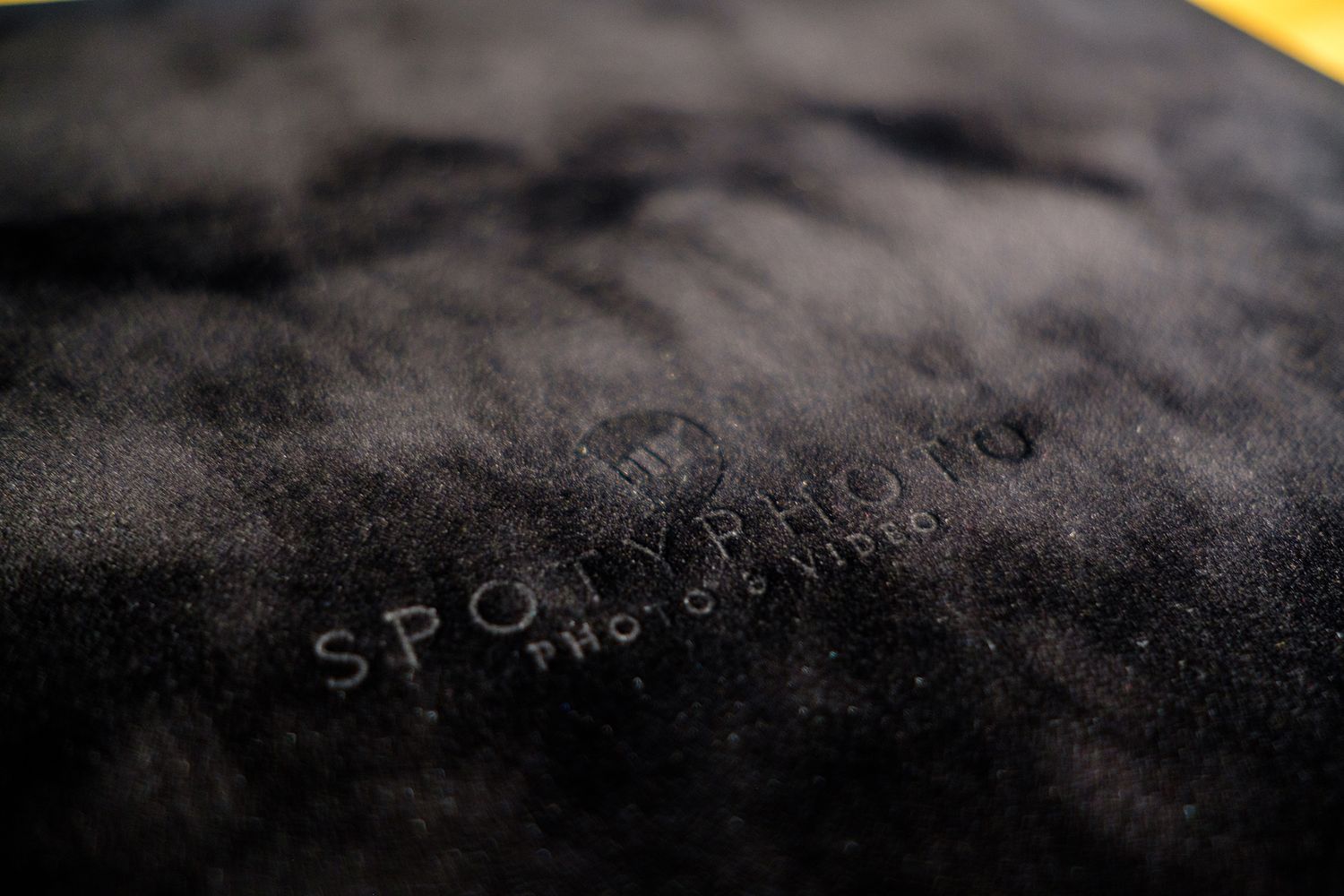 Water condensation droplets on a dark surface creating an abstract pattern.