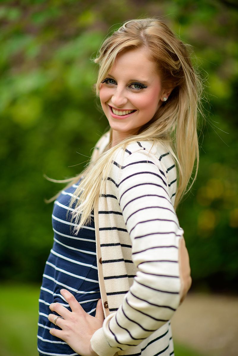 Four casual outdoor portraits in natural lighting showing navy striped shirt and cream striped sweater against blurred foliage.
