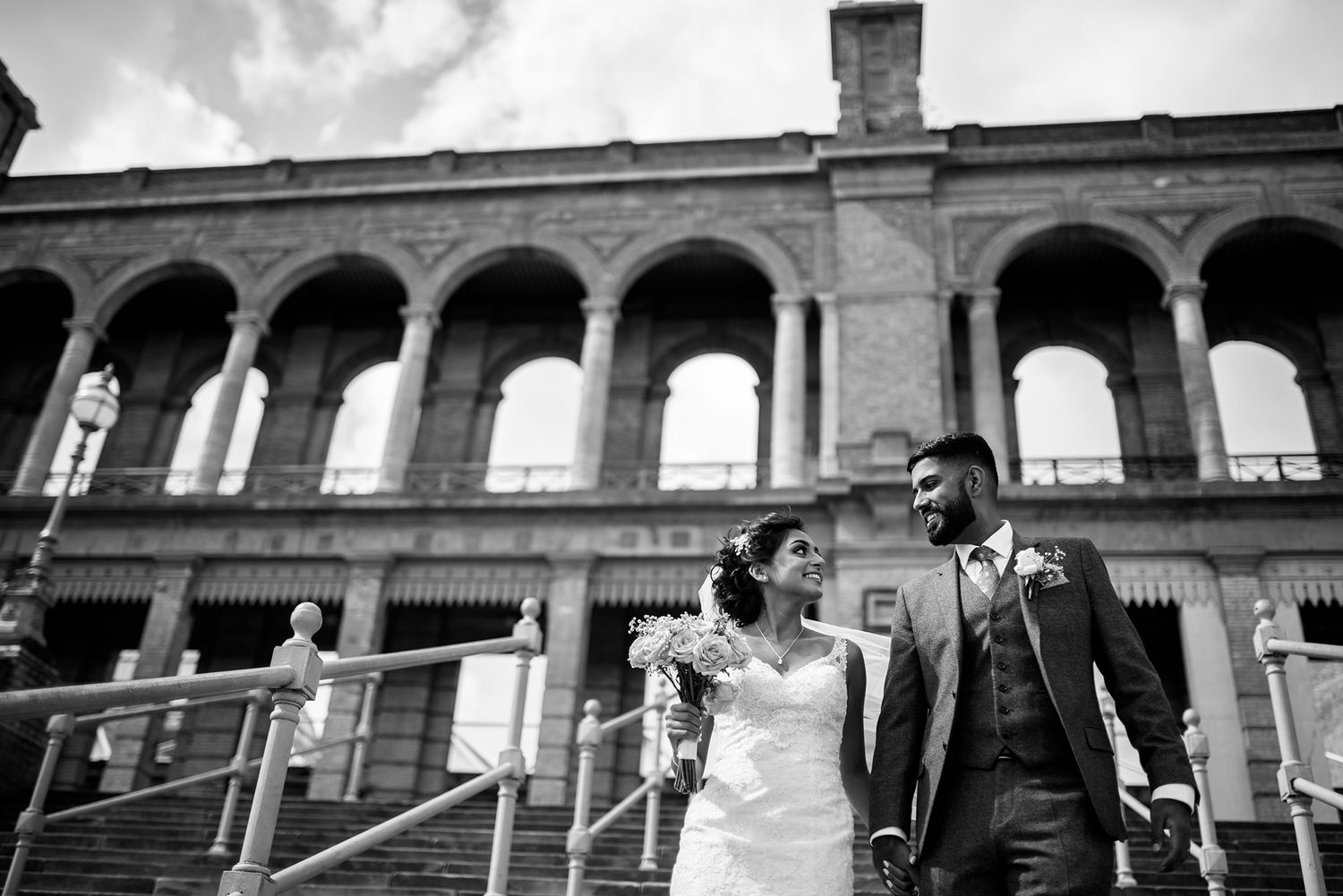 Black and white wedding photography showcasing architectural details of a historic venue.