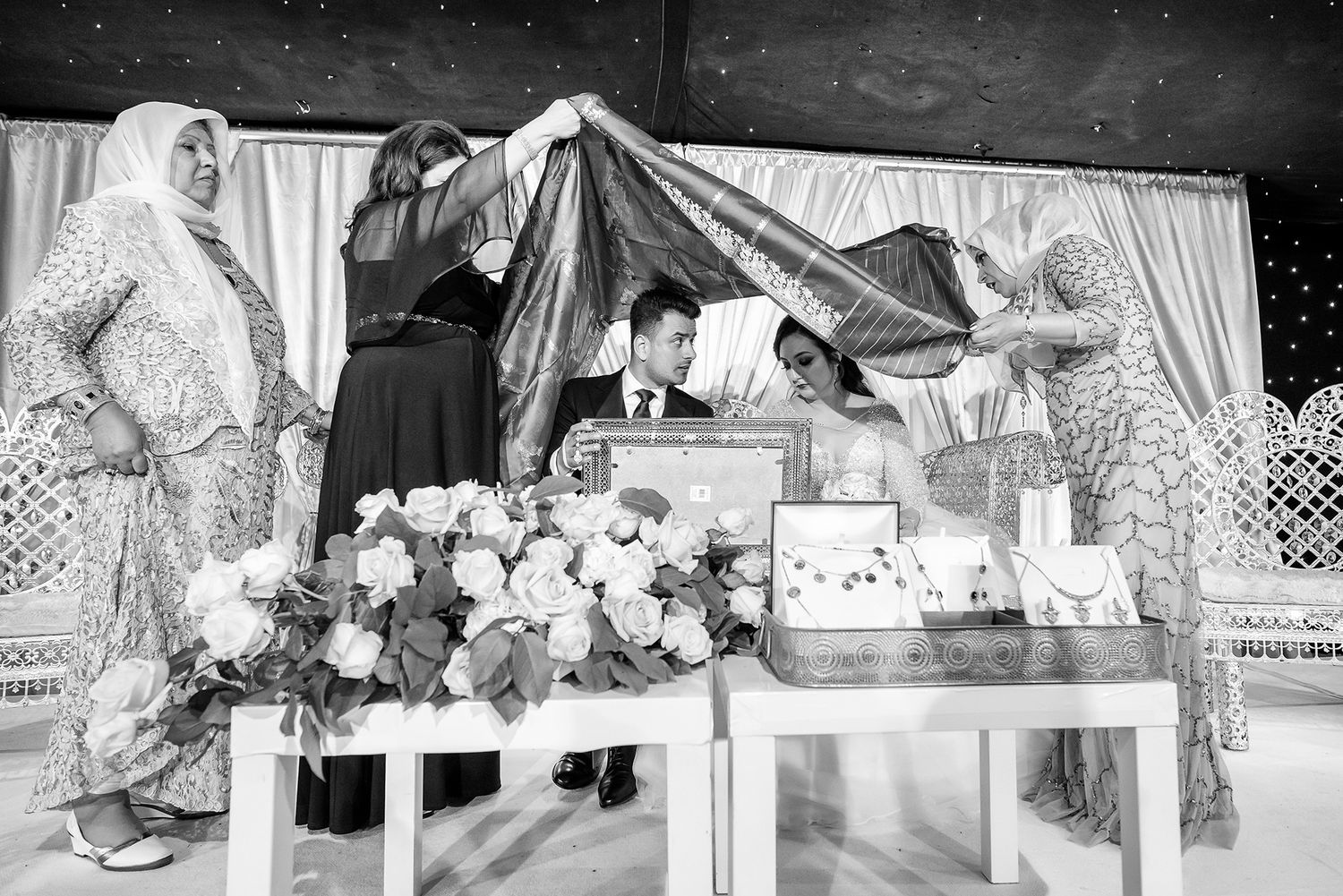 Black and white wedding photo sequence showing intimate moments during the reception.