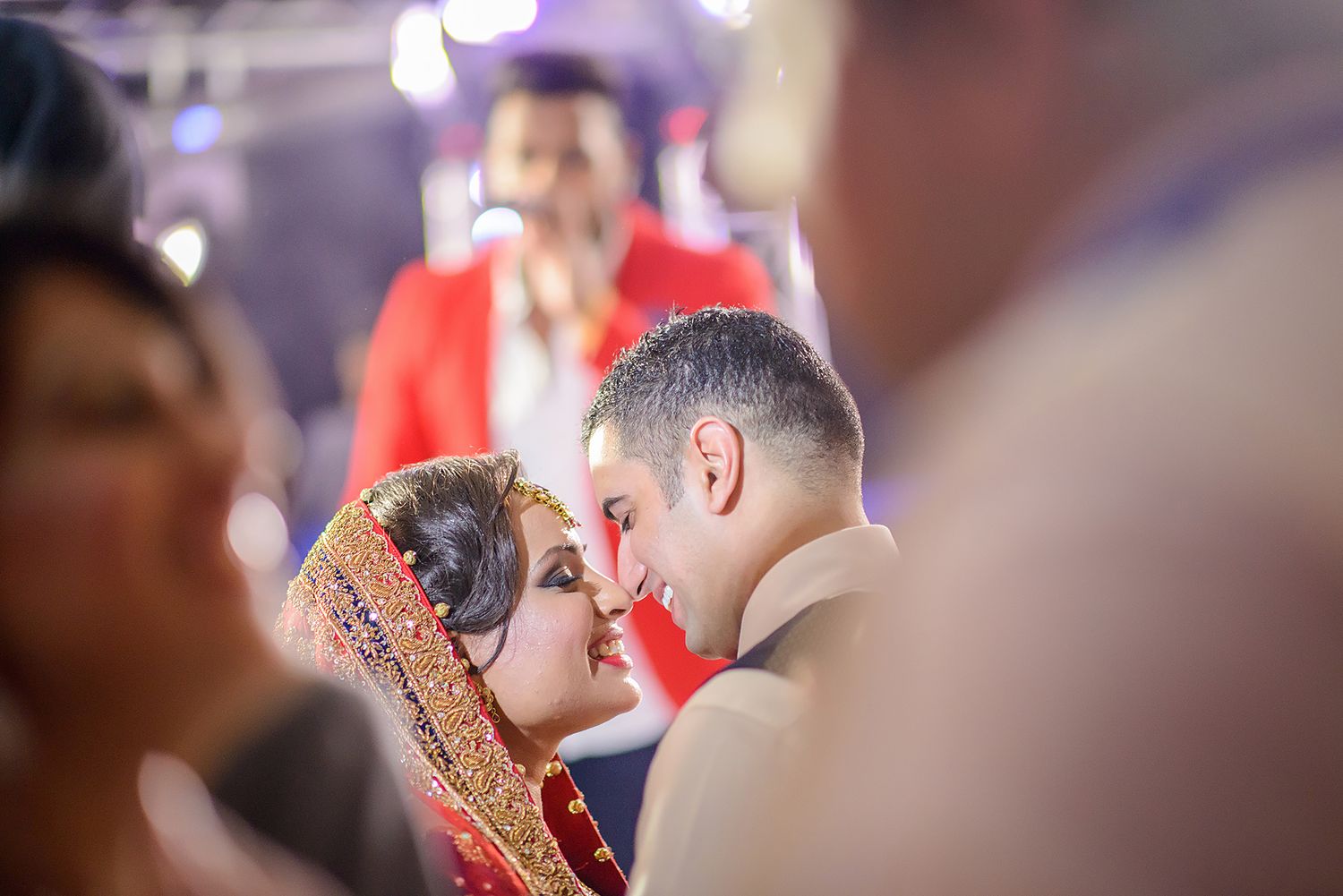 Wedding guests dancing closely together during a celebratory moment.