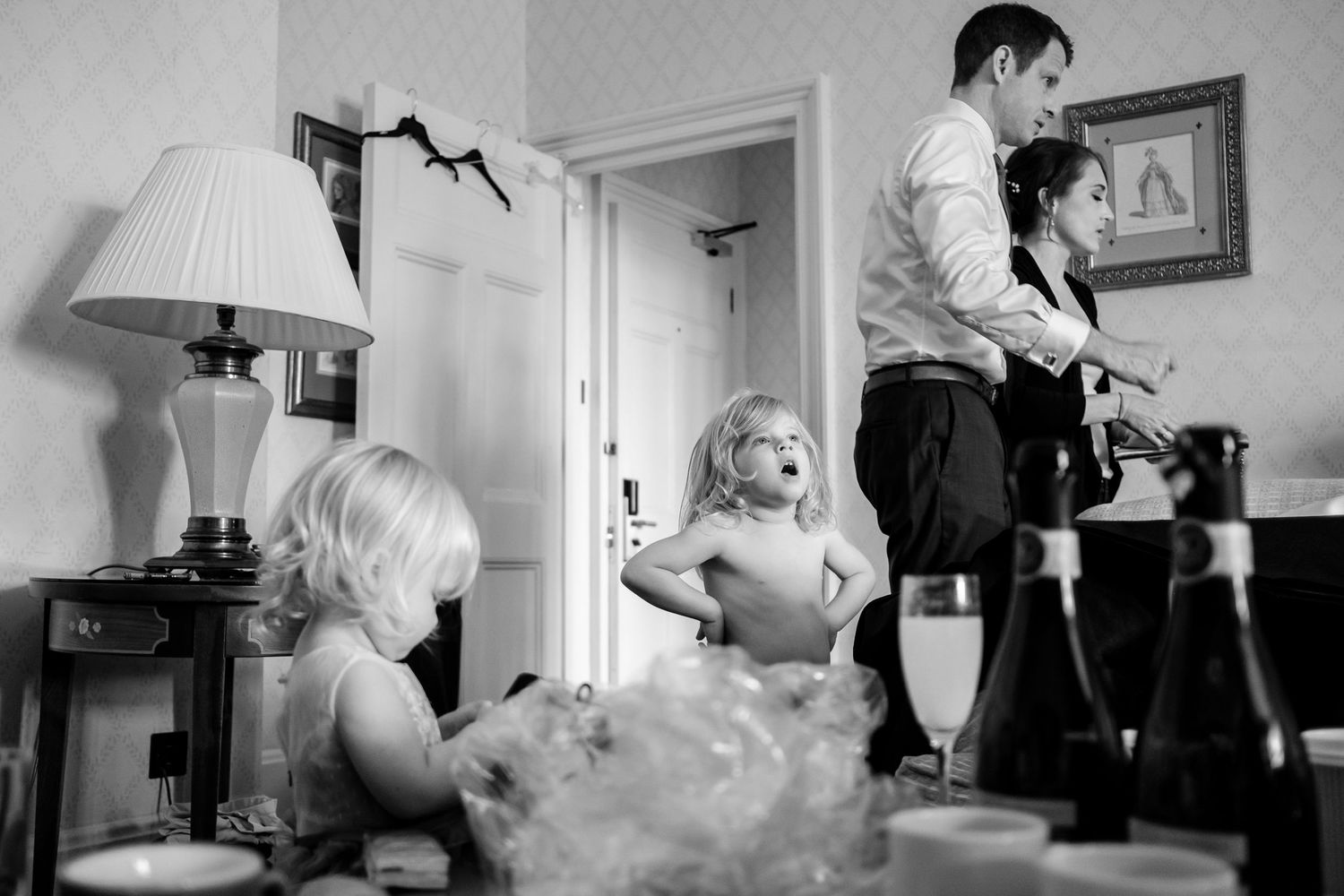 A series of black and white film noir style photographs showing dramatic lighting and intimate indoor scenes.
