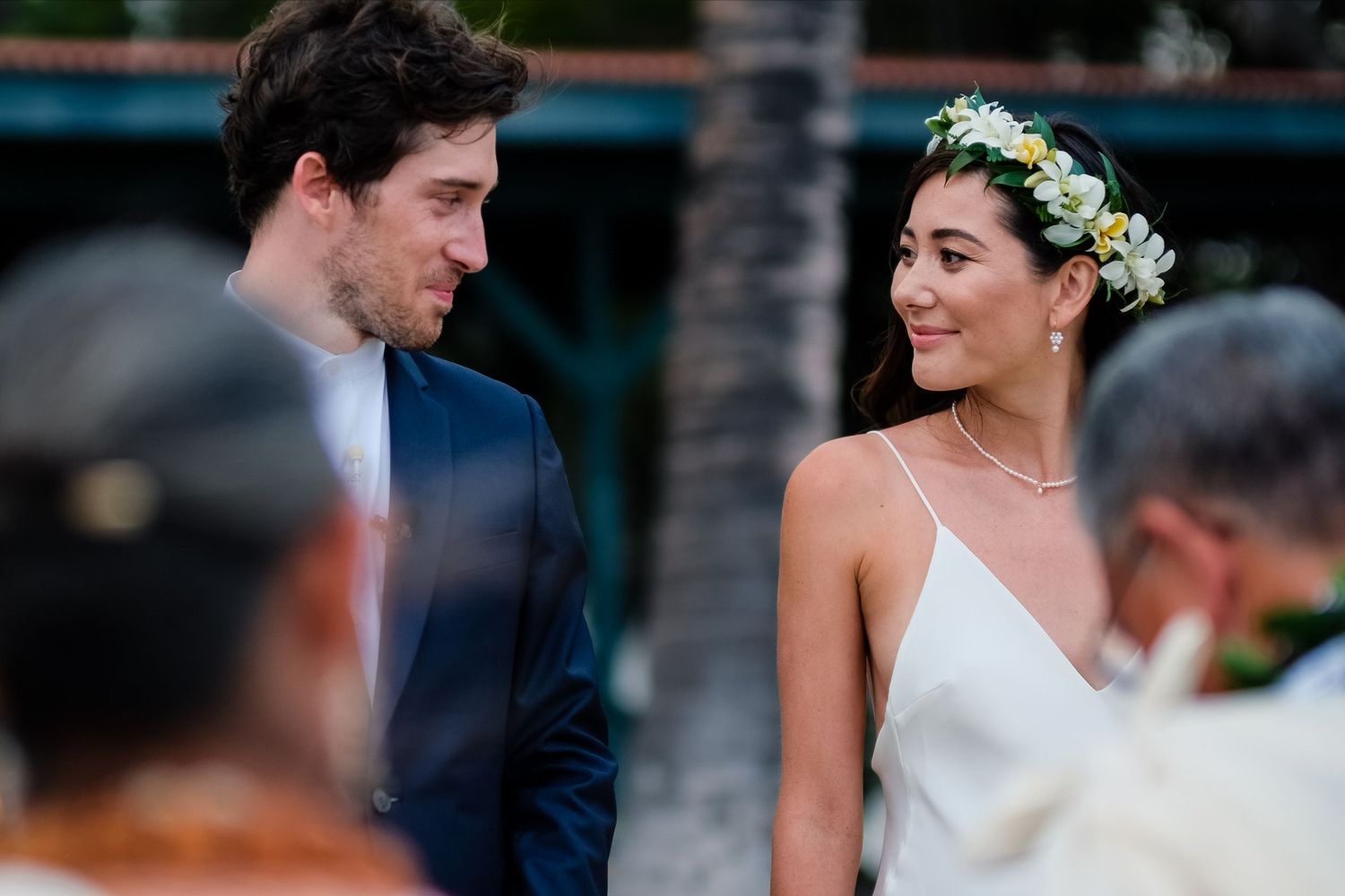 Elegant outdoor wedding celebration with white floral decorations and natural greenery.