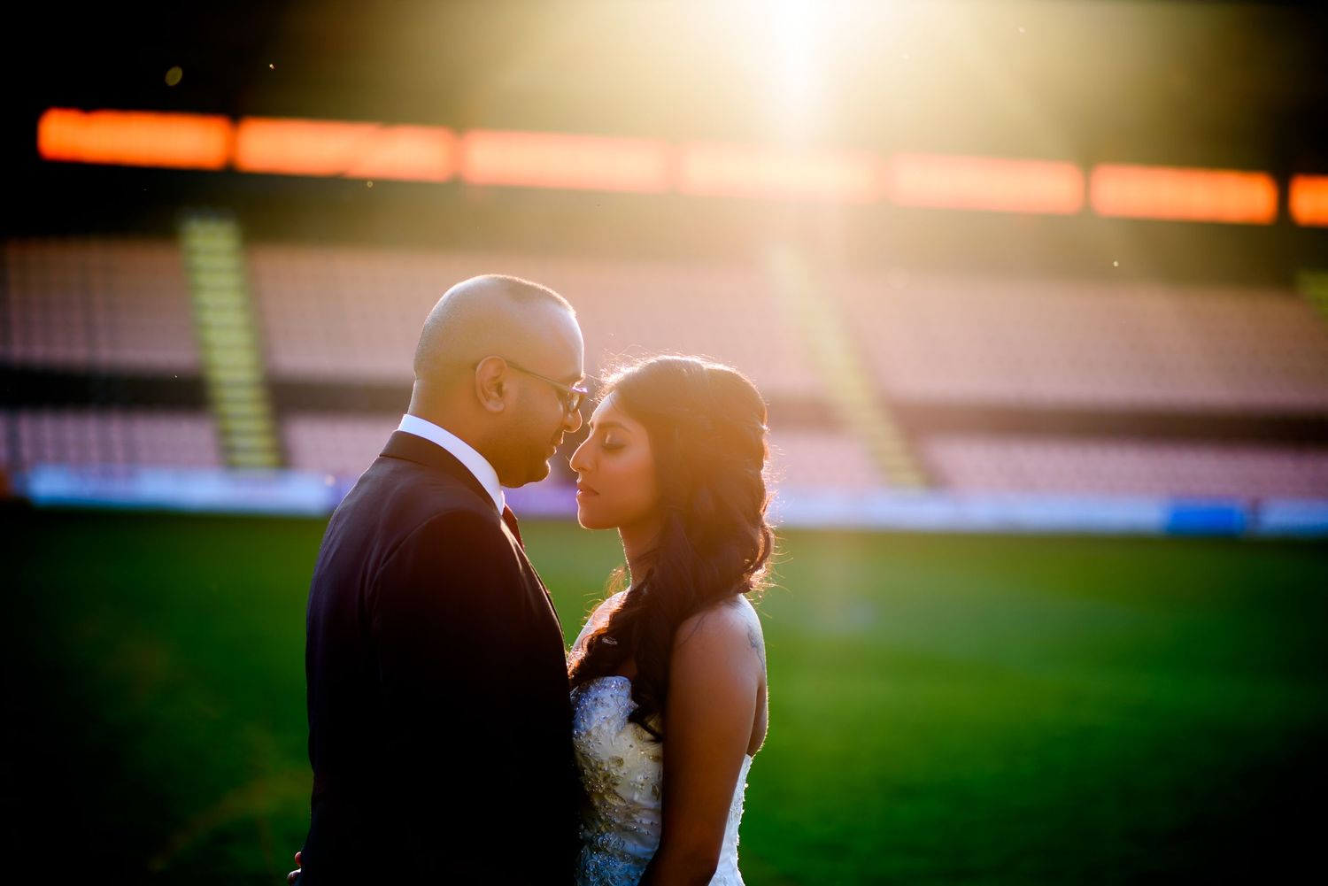Silhouettes against a warm sunset backdrop in an outdoor setting.