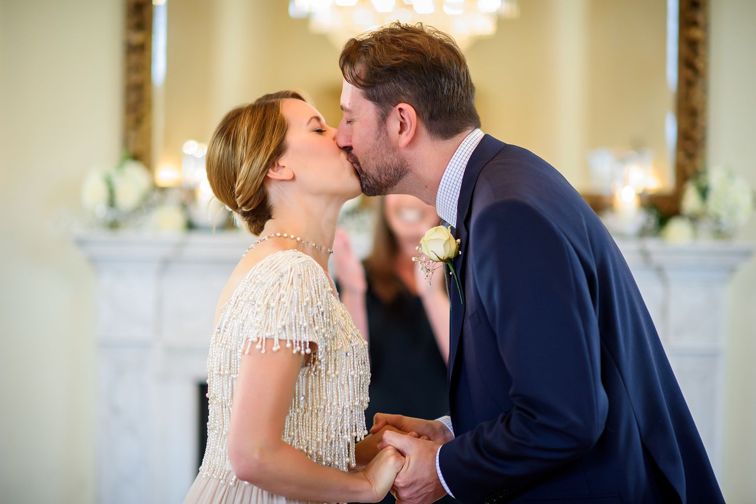 Romantic wedding moment shared in an elegantly decorated reception room.