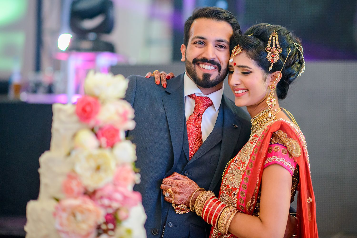 Wedding reception scene with colorful lighting and festive atmosphere.