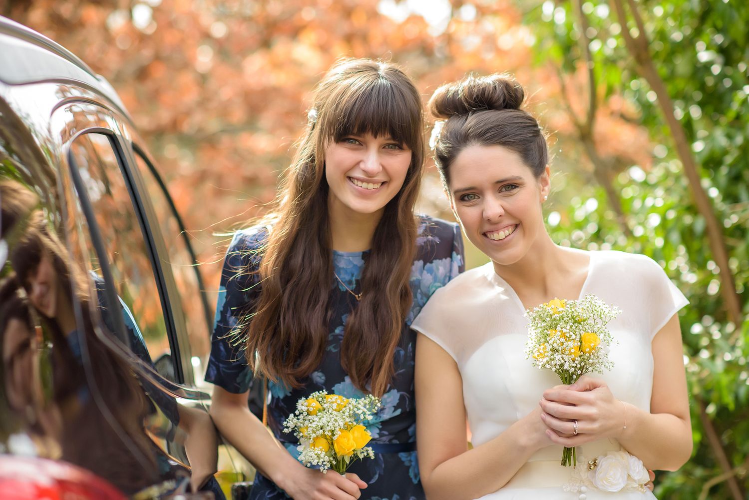 Outdoor portrait session featuring couples and wedding party members holding yellow flowers.