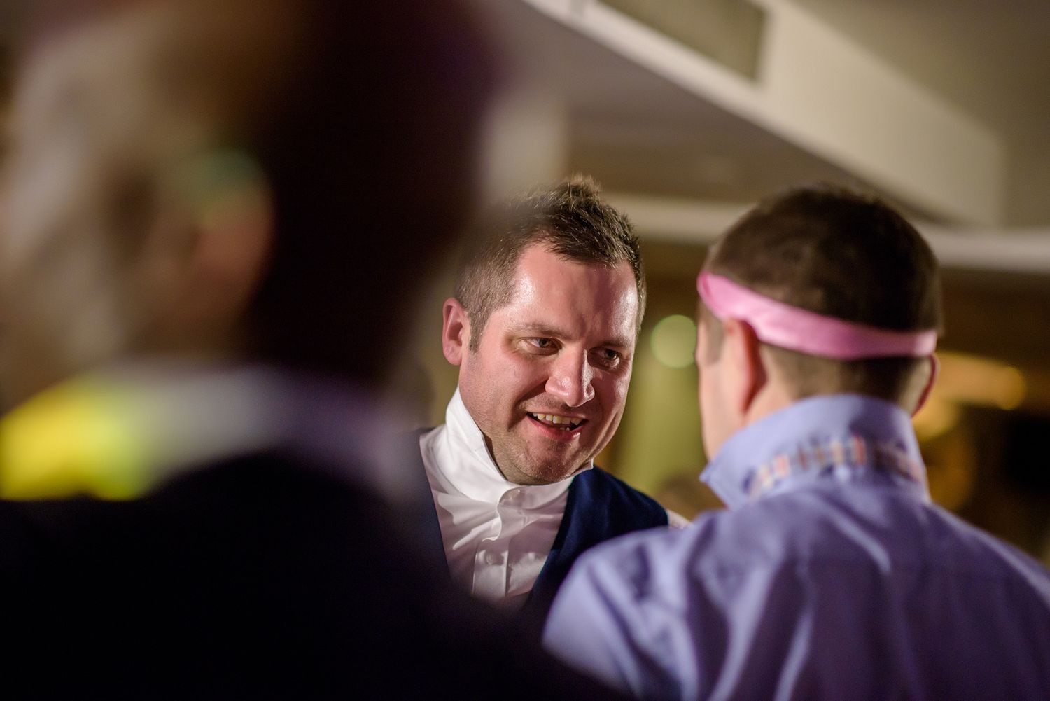Intimate candid moments between wedding guests during the evening reception.
