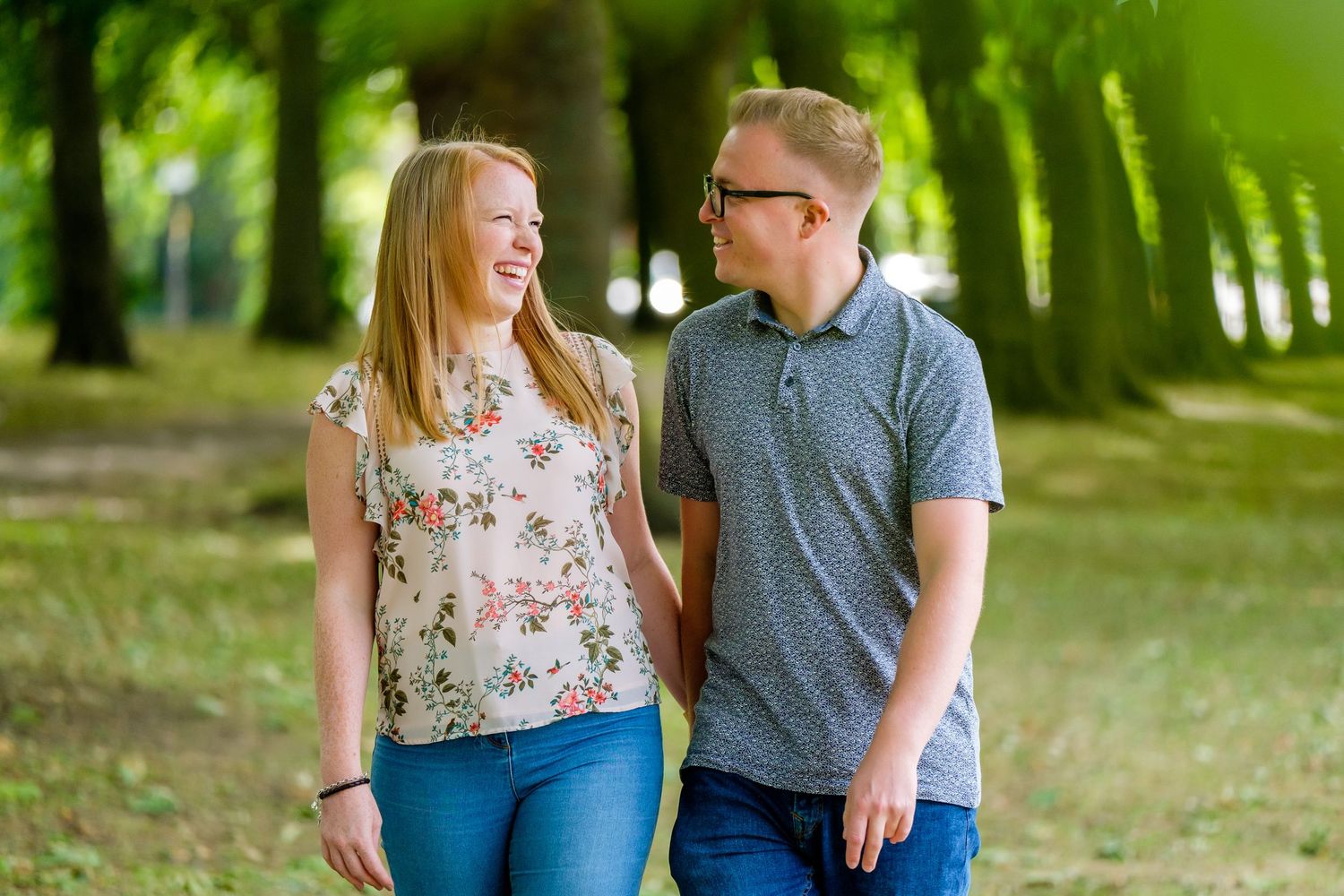 Outdoor engagement photoshoot in a green park setting during golden hour.