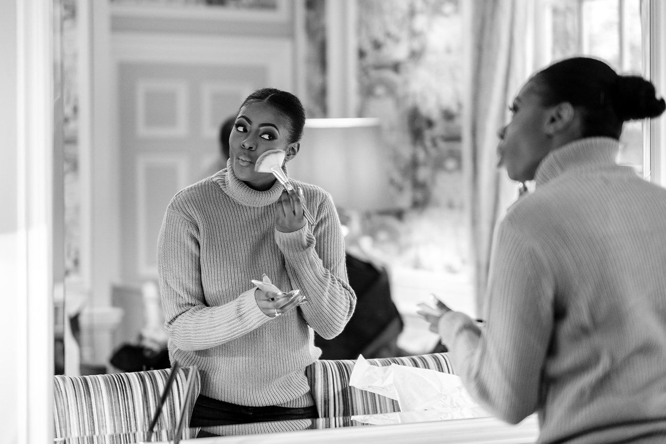 An intimate moment captured through window reflections in a bright interior space.
