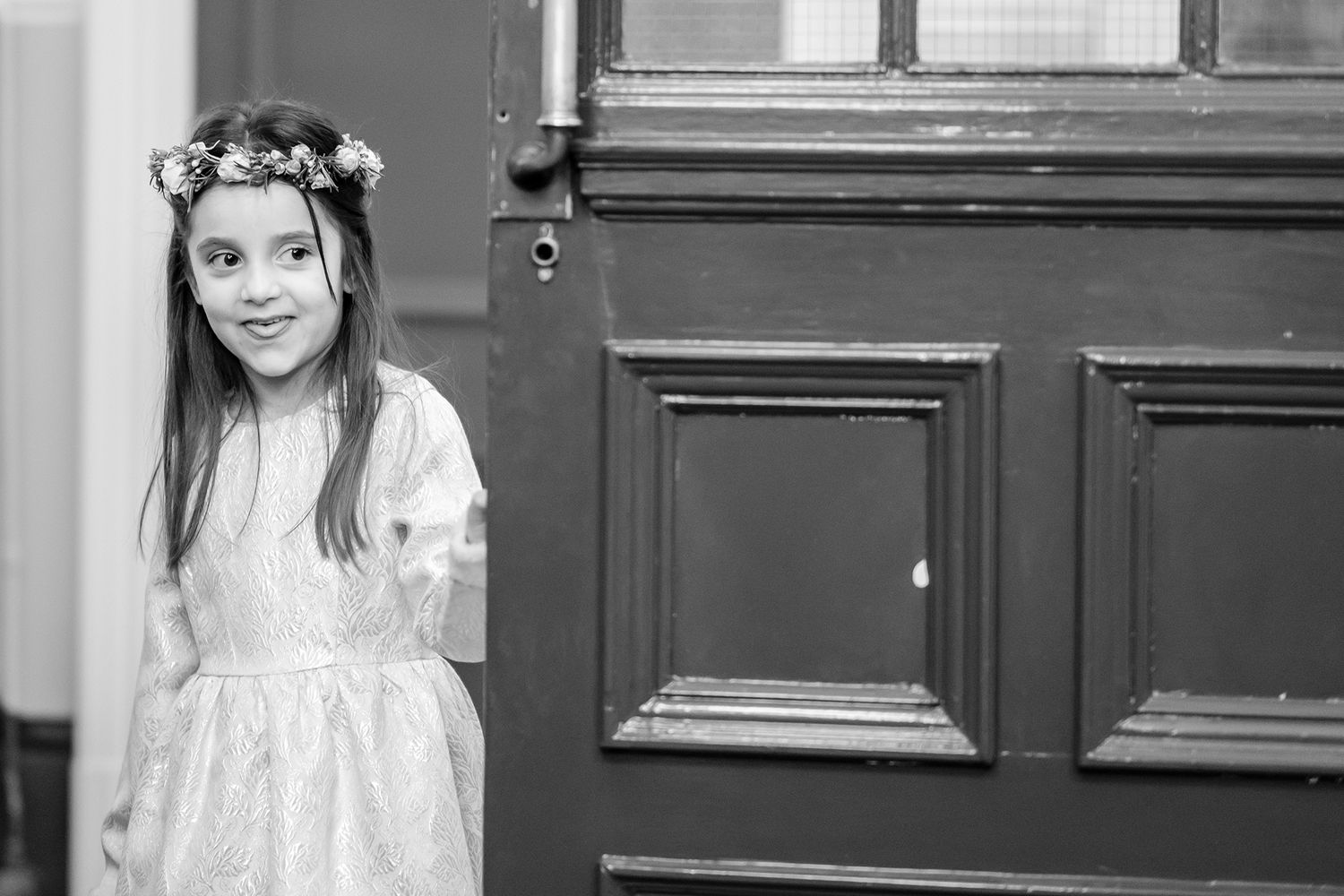 A series of candid black and white photos taken during an indoor wedding reception.