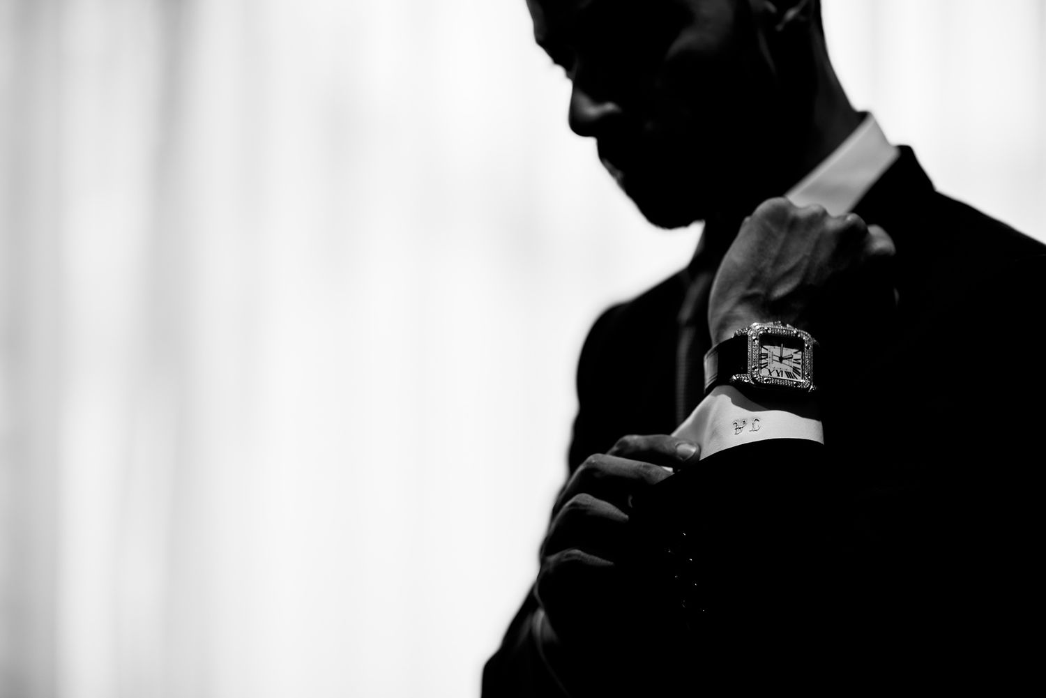Side view silhouettes of attendees at a formal event with backlighting.