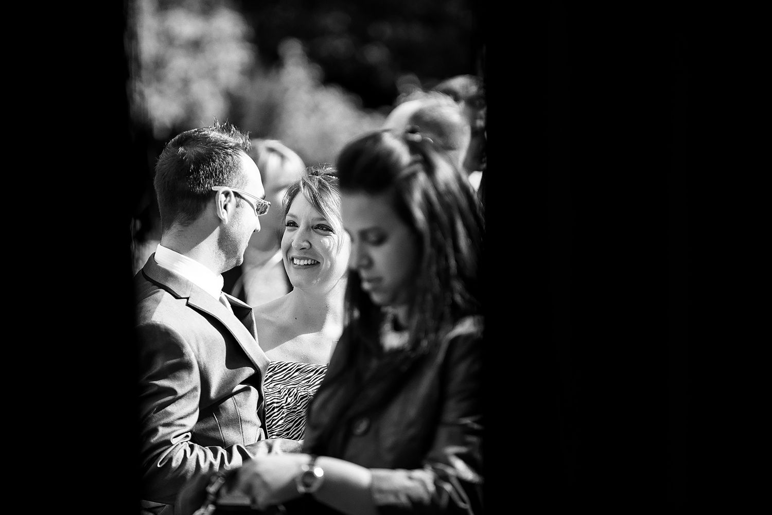 Black and white candid moment captured during wedding celebration.