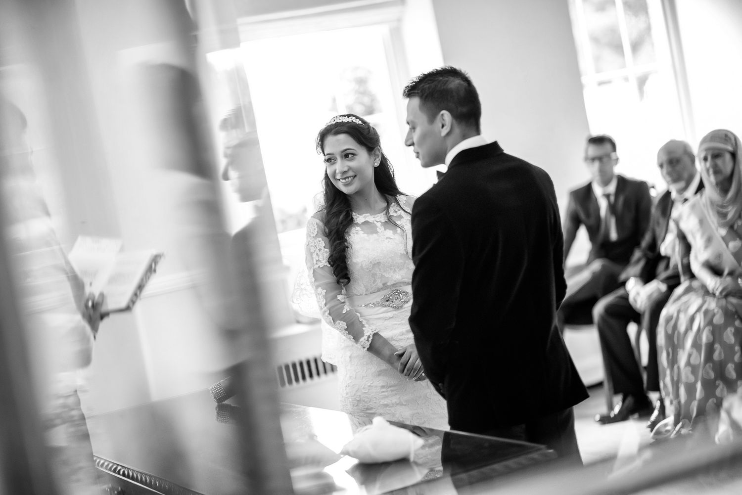 Interior wedding reception scene with soft natural lighting streaming through windows.