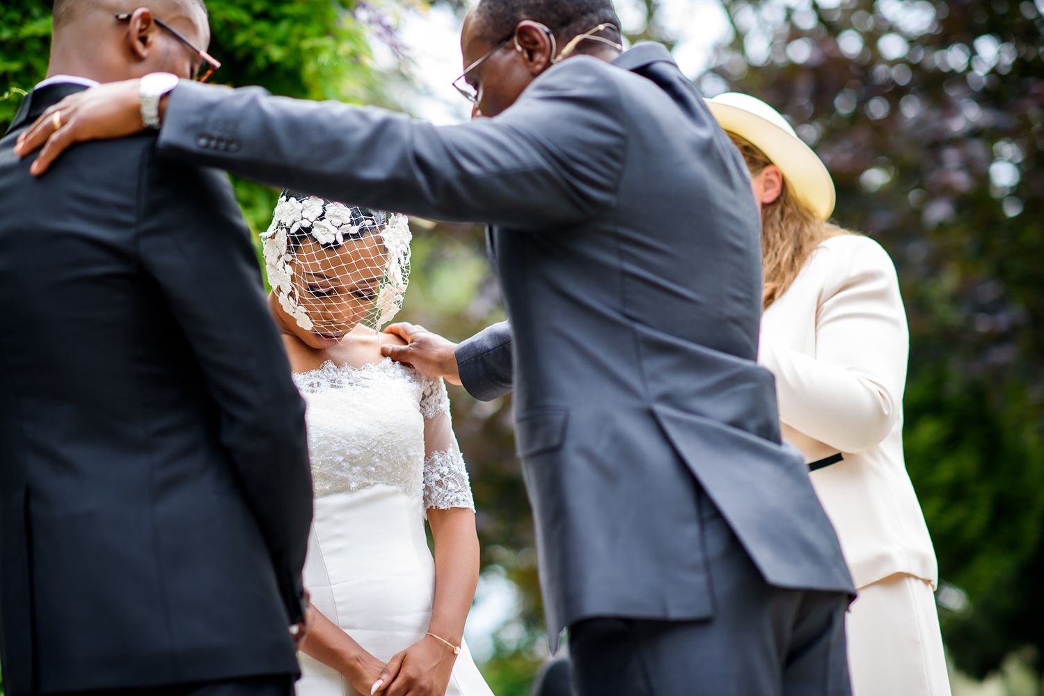 Wedding party members dancing and celebrating outdoors in formal attire.