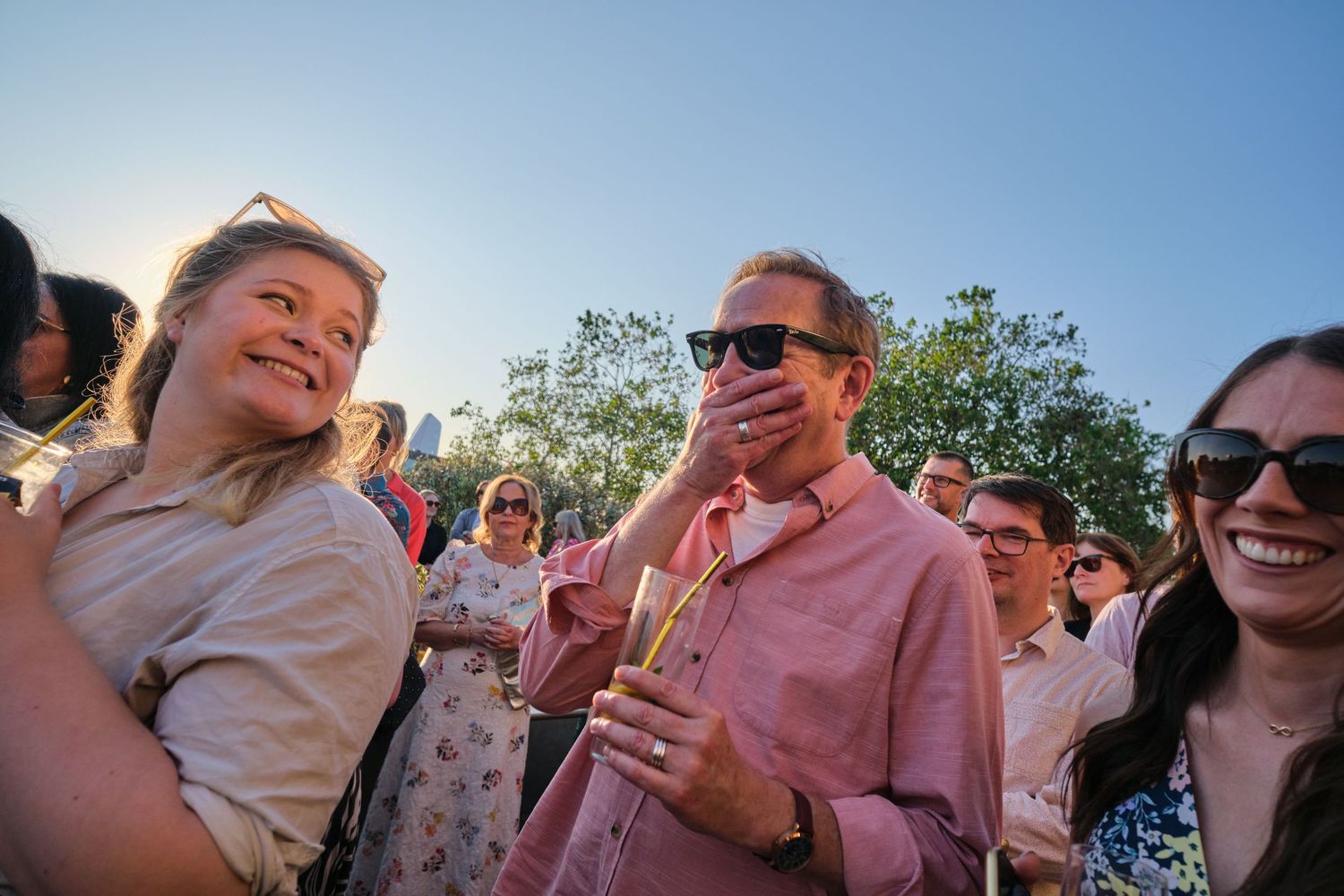 Wedding guests enjoying an outdoor celebration during golden hour.