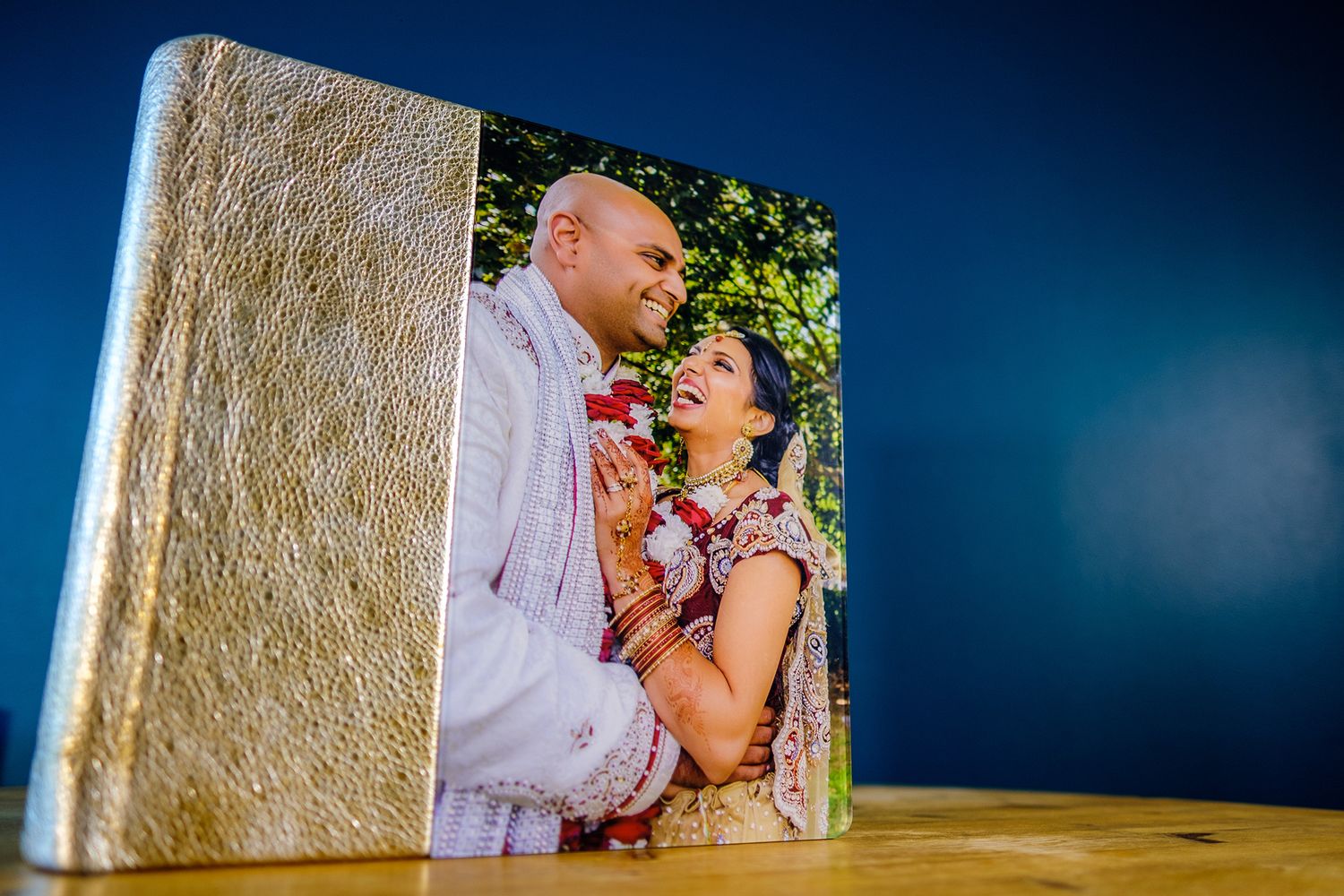 Wedding photo album pages displayed against a deep blue background.