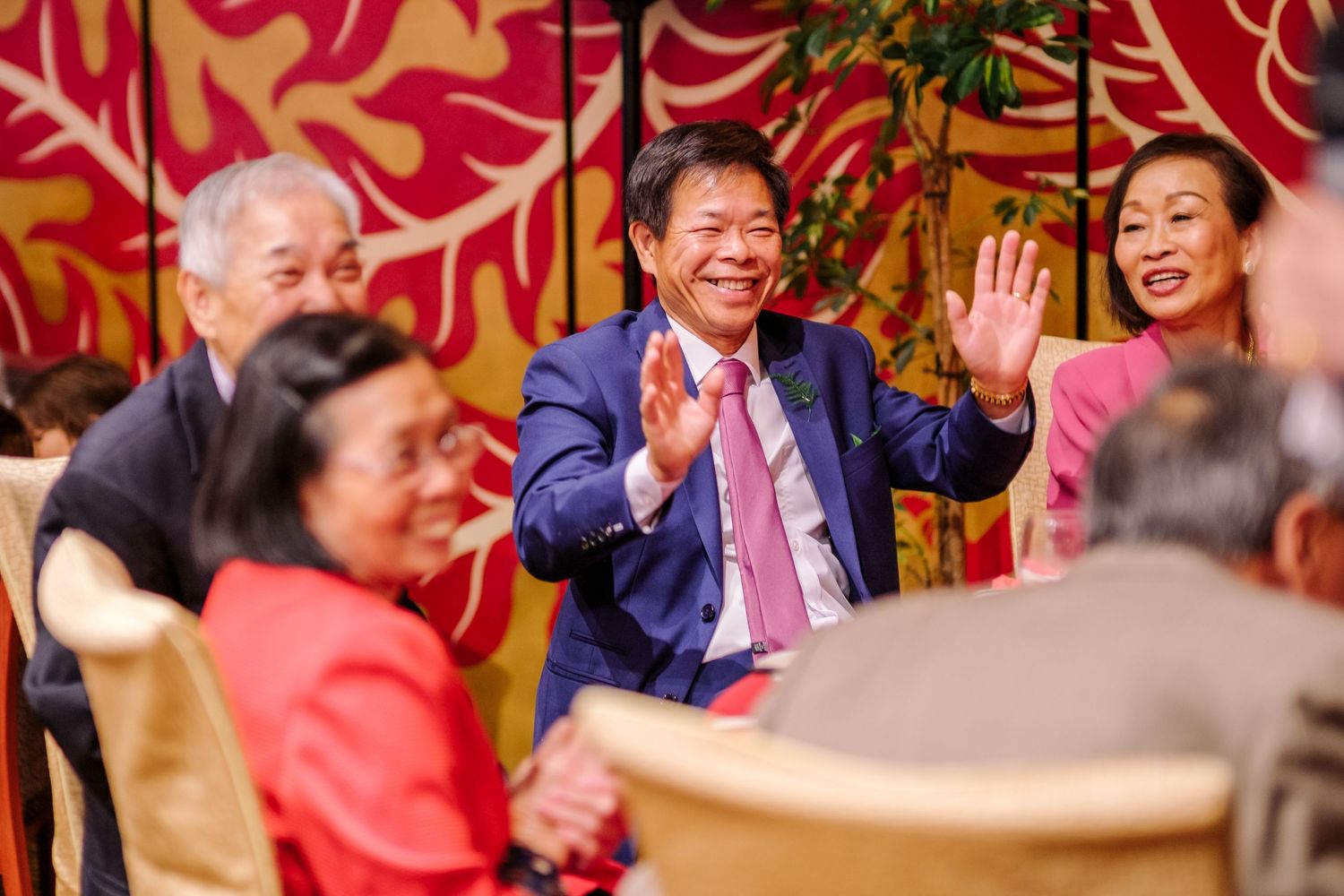 Celebratory atmosphere at an Asian restaurant with red decor and hanging lanterns.