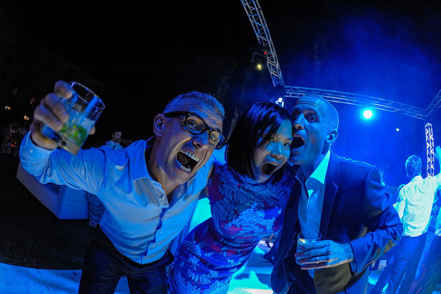 Party scene with blue lighting and dancing silhouettes.