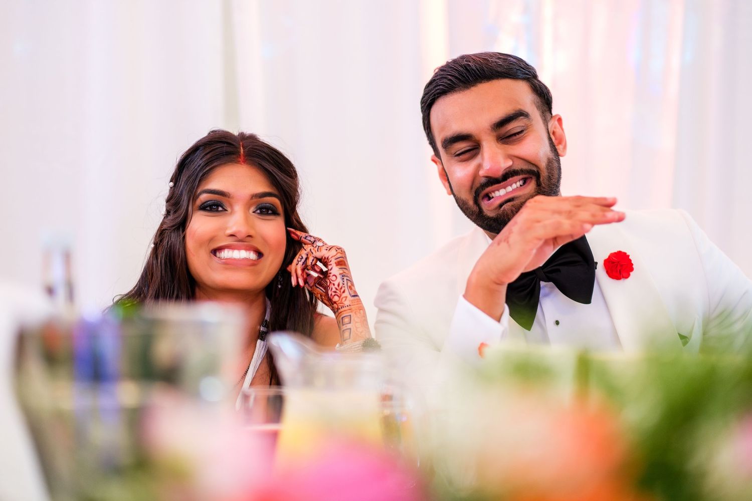 Joyful reactions and laughter during wedding reception speeches and toasts.