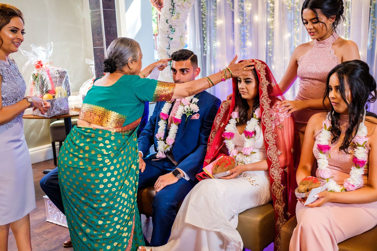 Guests gather at a festive celebration with colorful decorations and traditional attire.