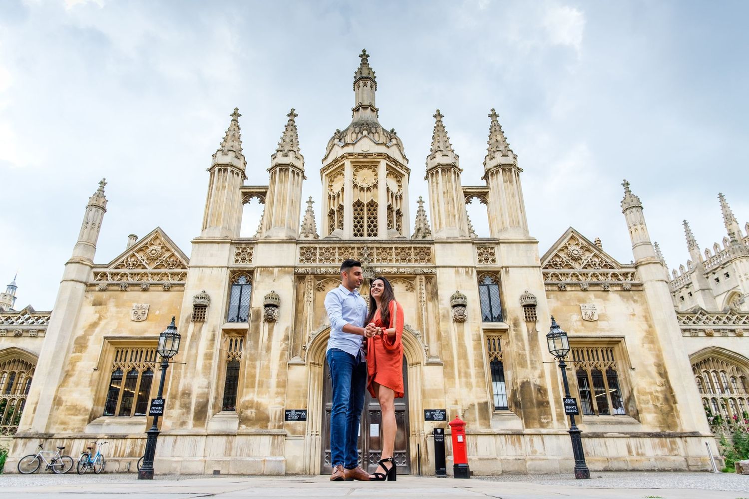 Gothic architecture of Kings College Chapel in Cambridge showcases ornate spires and stone details against cloudy sky.