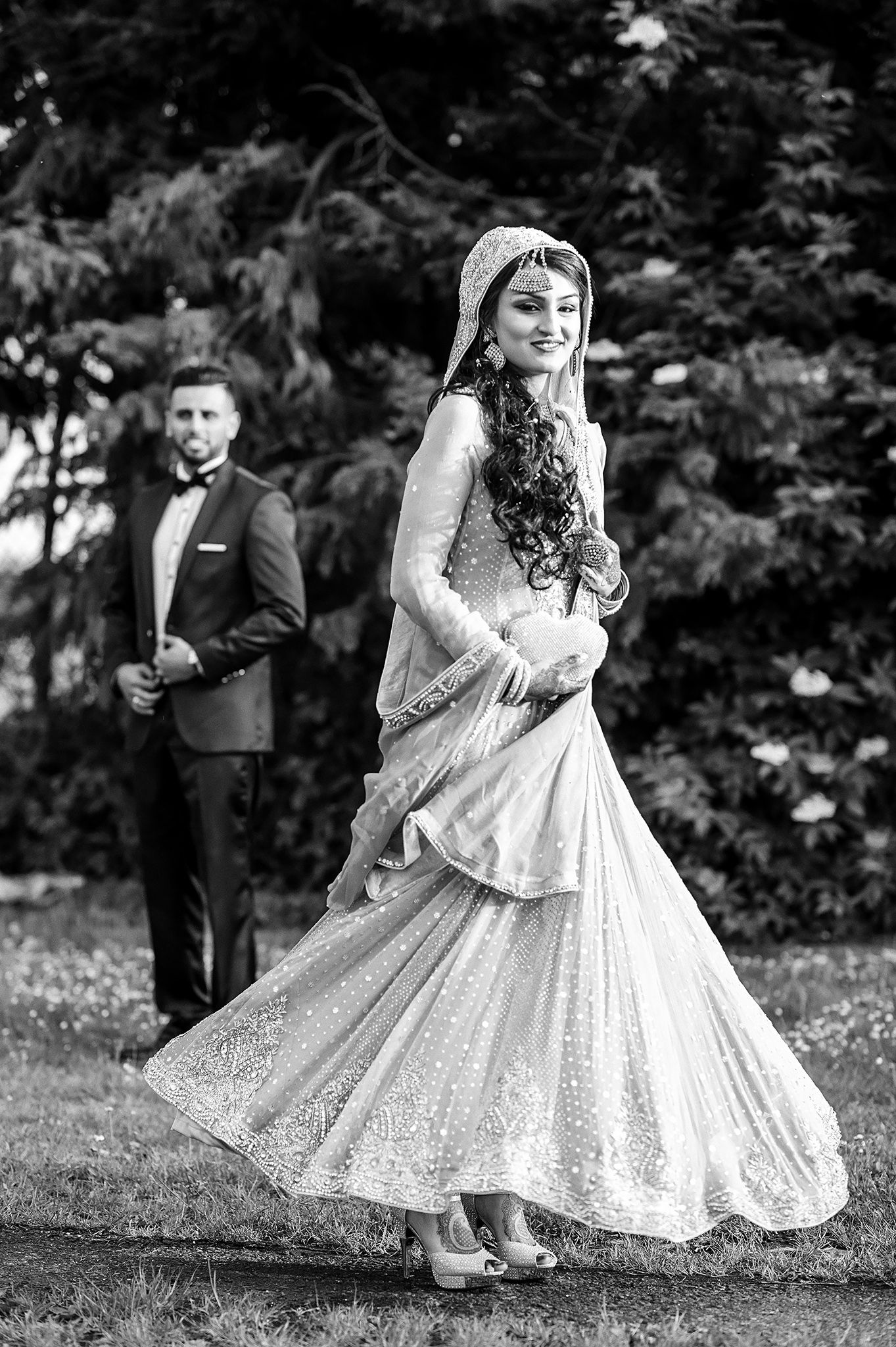 Black and white wedding photo showing elegant dress with intricate details.