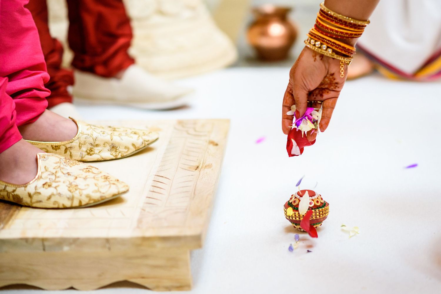 Close-up of traditional Indian wedding bangles and jewelry on decorated table.