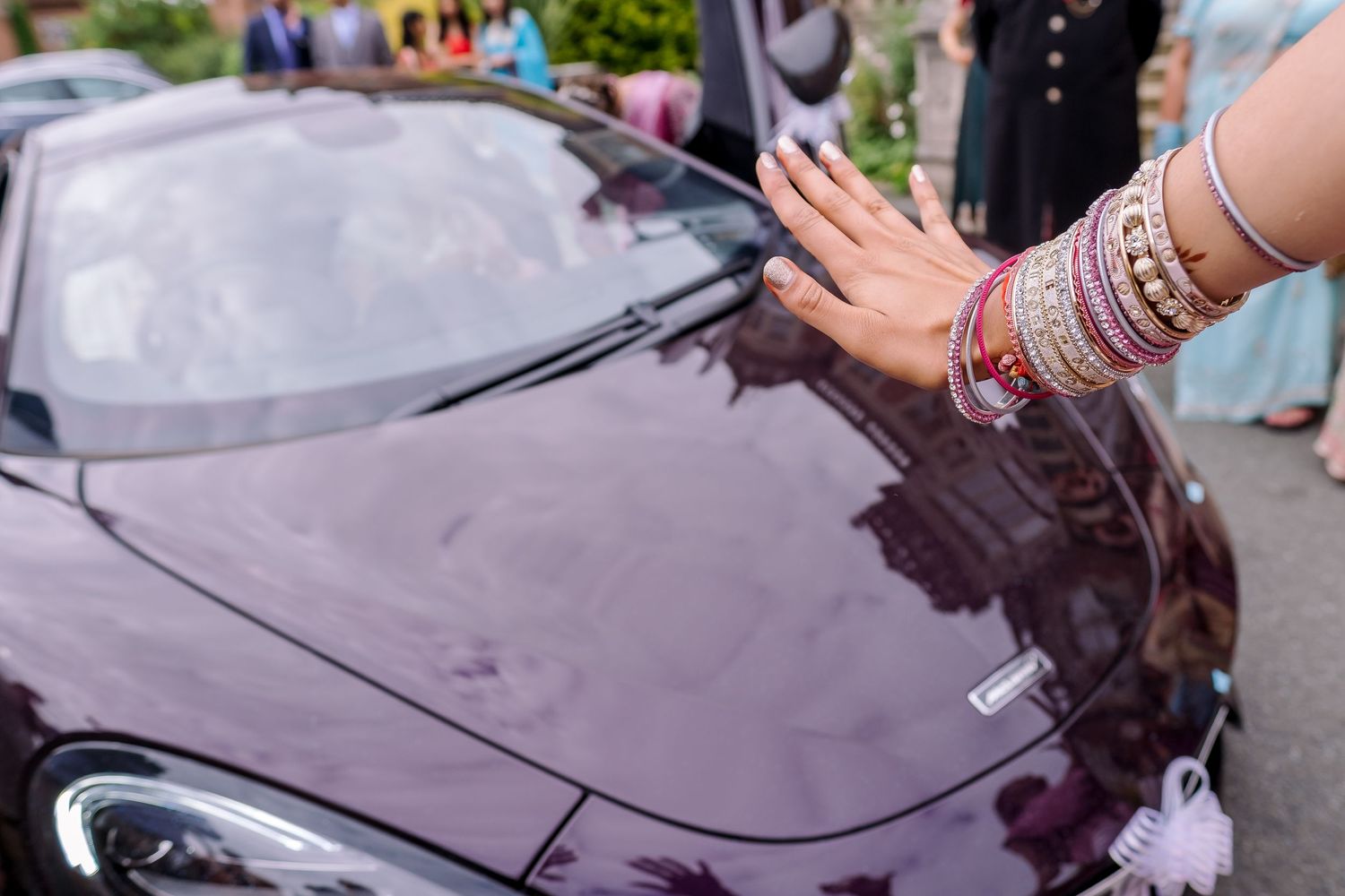 Close-up of decorated luxury car with traditional wedding ornaments.