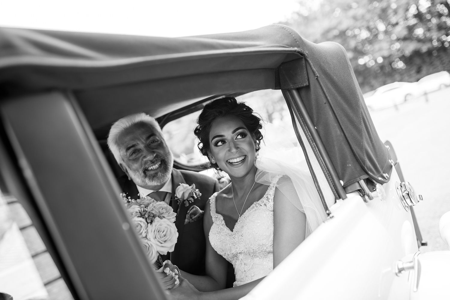 Joyful moment captured through vintage car window on special occasion.