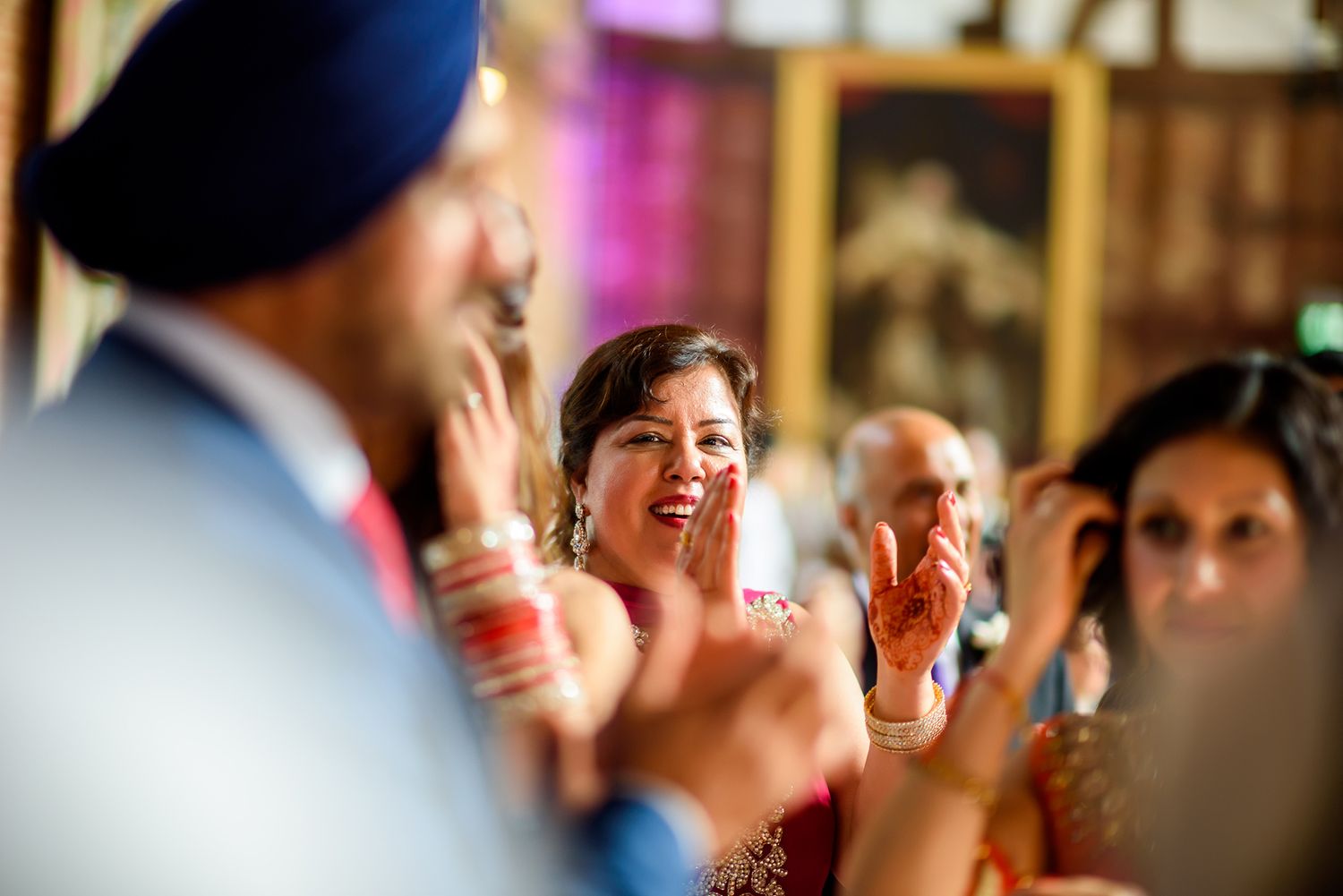 Wedding guests cheer and celebrate during an energetic reception party.