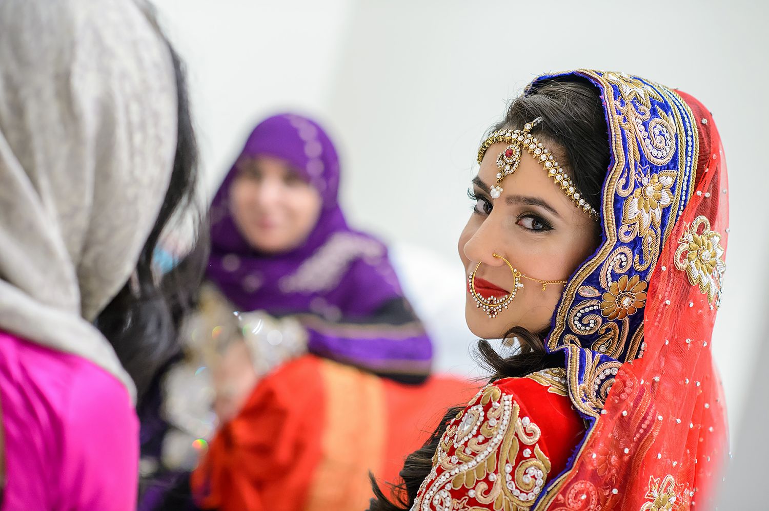 Intricate wedding fashion details with embroidered fabrics in rich colors.
