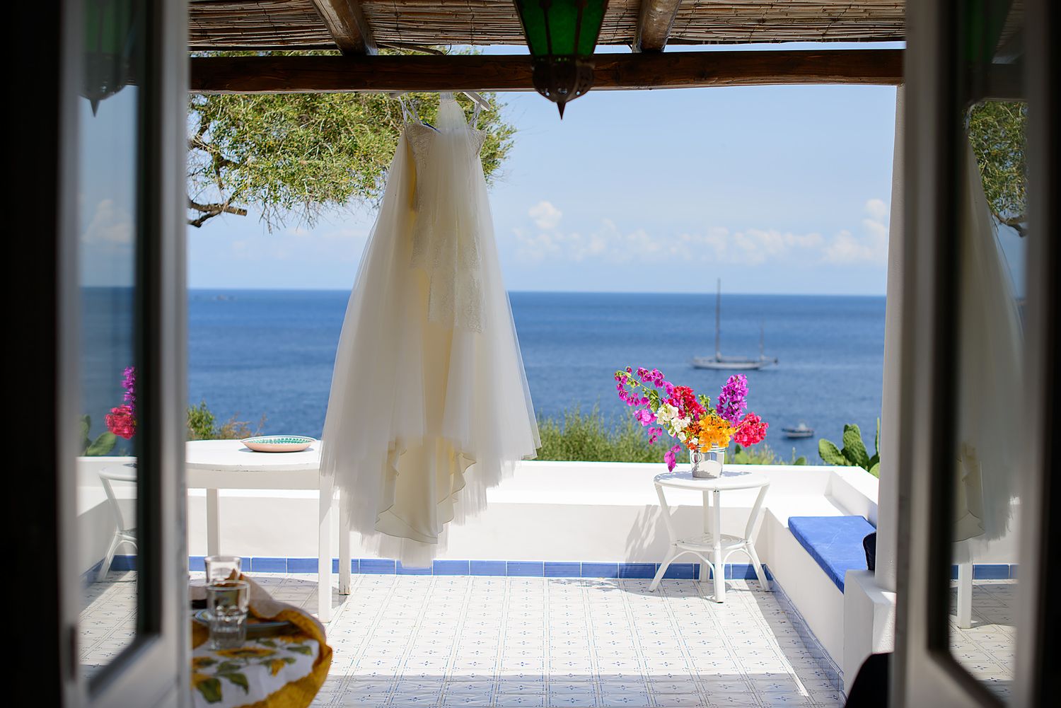 Elegant seaside wedding venue with white draped canopies and ocean views.