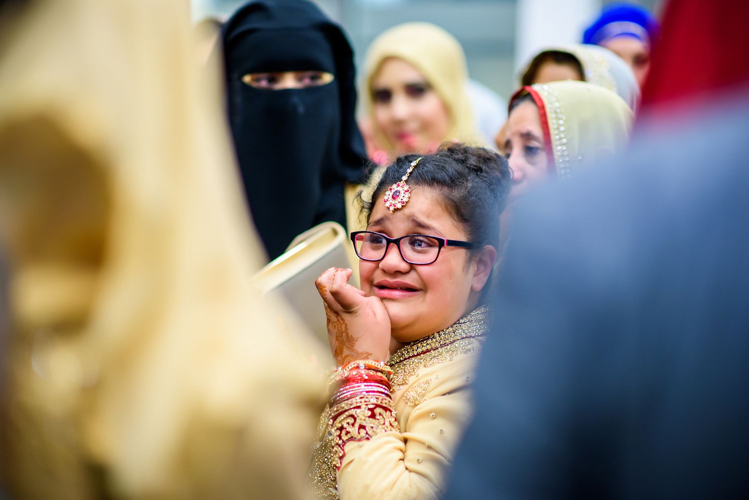 Candid moments from a cultural wedding celebration with guests in traditional dress.