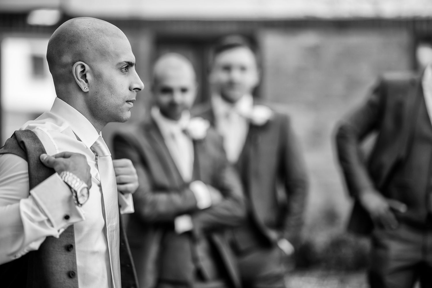Black and white candid shots capturing wedding party reactions.