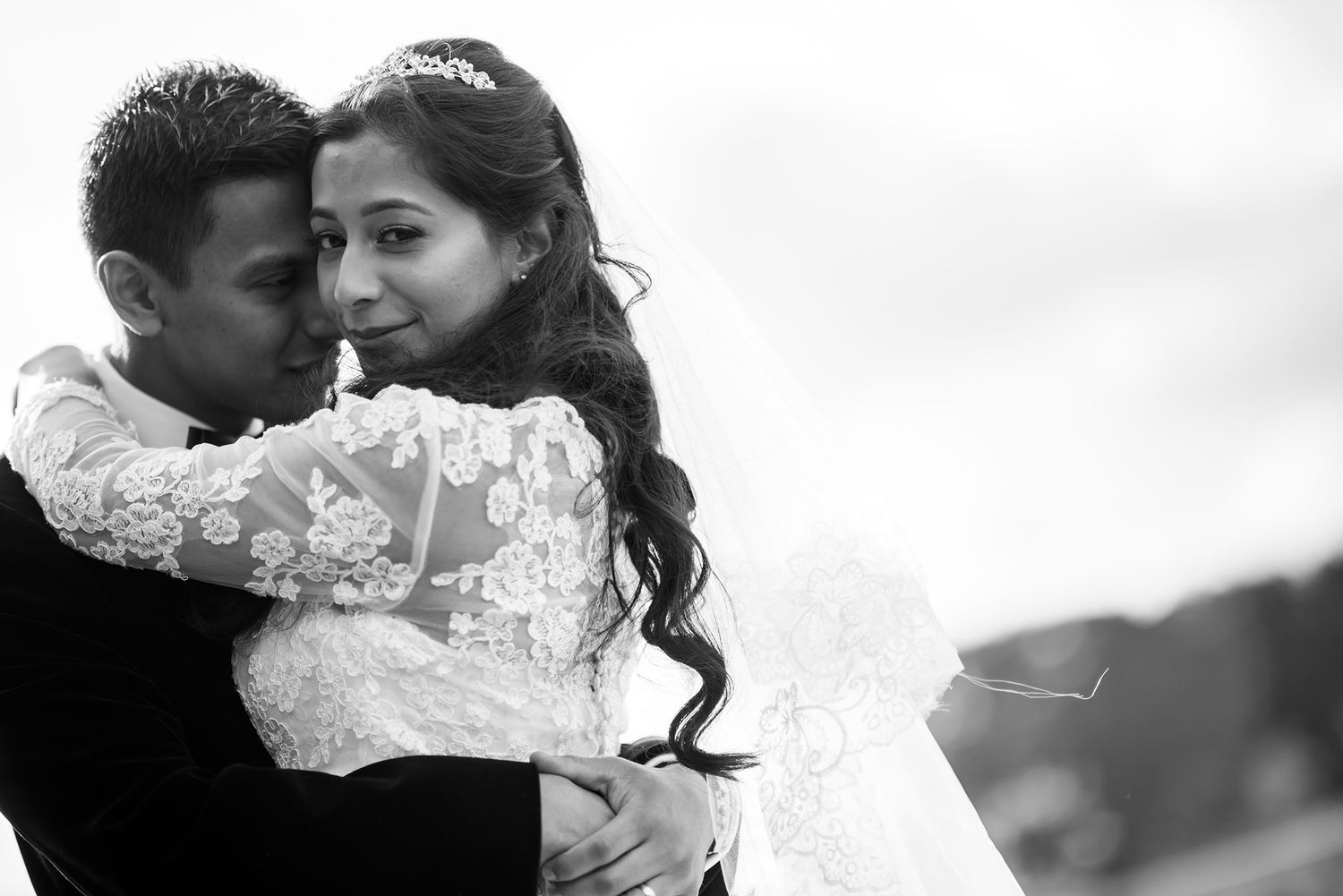 Romantic black and white wedding photo with soft lighting.