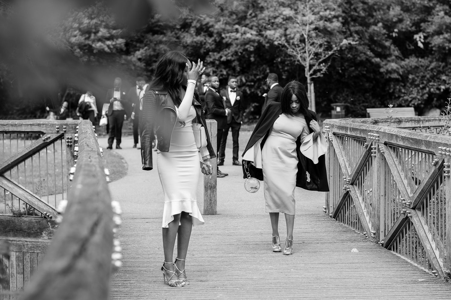 Wedding guests strolling along a scenic bridge pathway during the celebration.