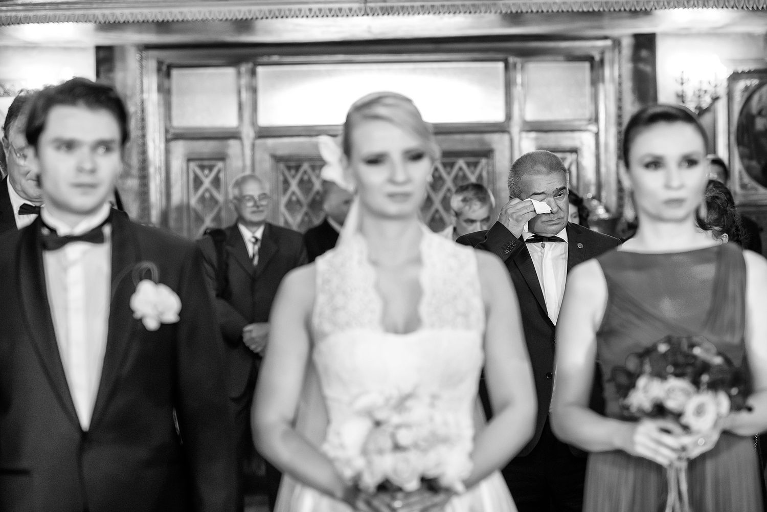 Formal wedding party lined up in classic black and white photograph.