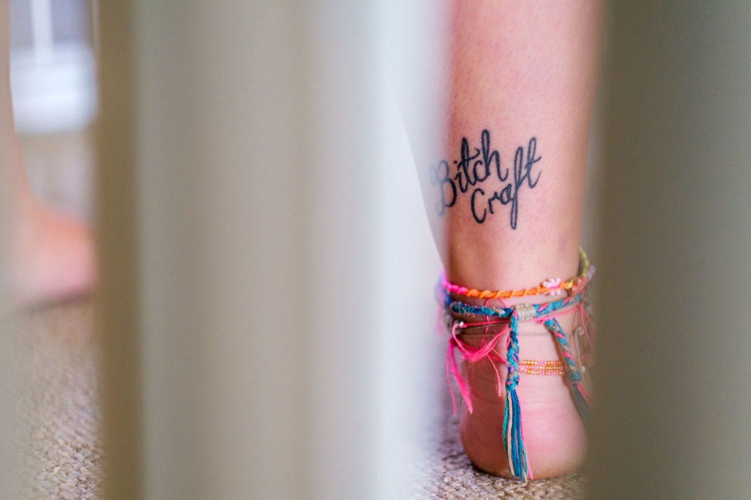 Colorful tattoo art visible on someone's arm with decorative bracelets.