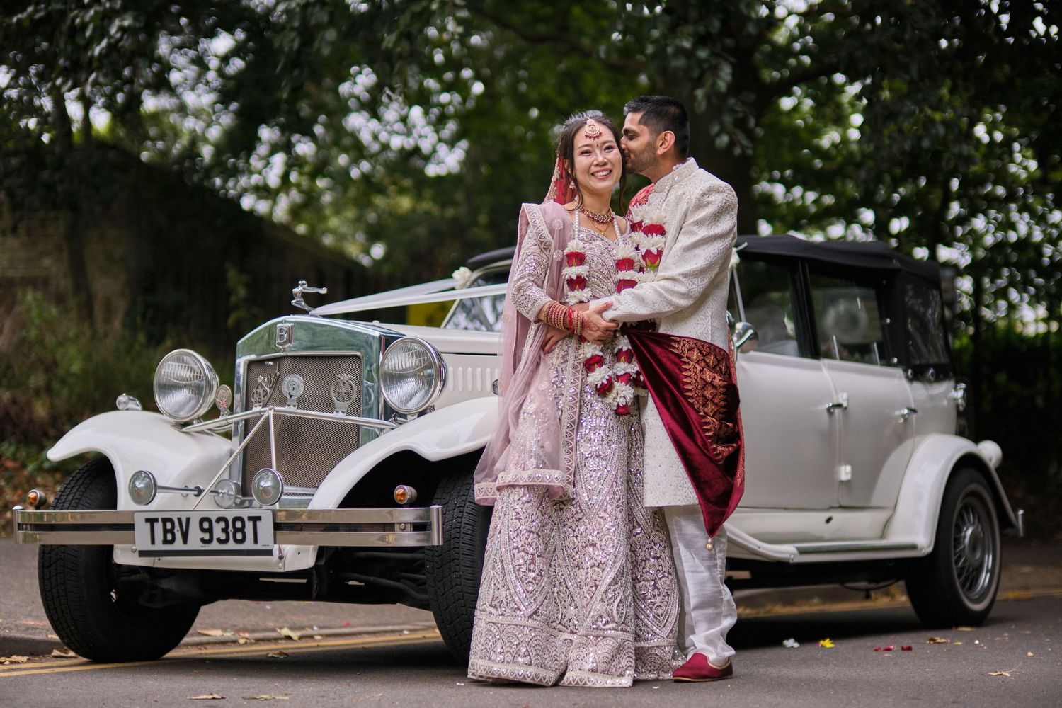 Classic vintage cars parked alongside a decorative outdoor venue during a special event.