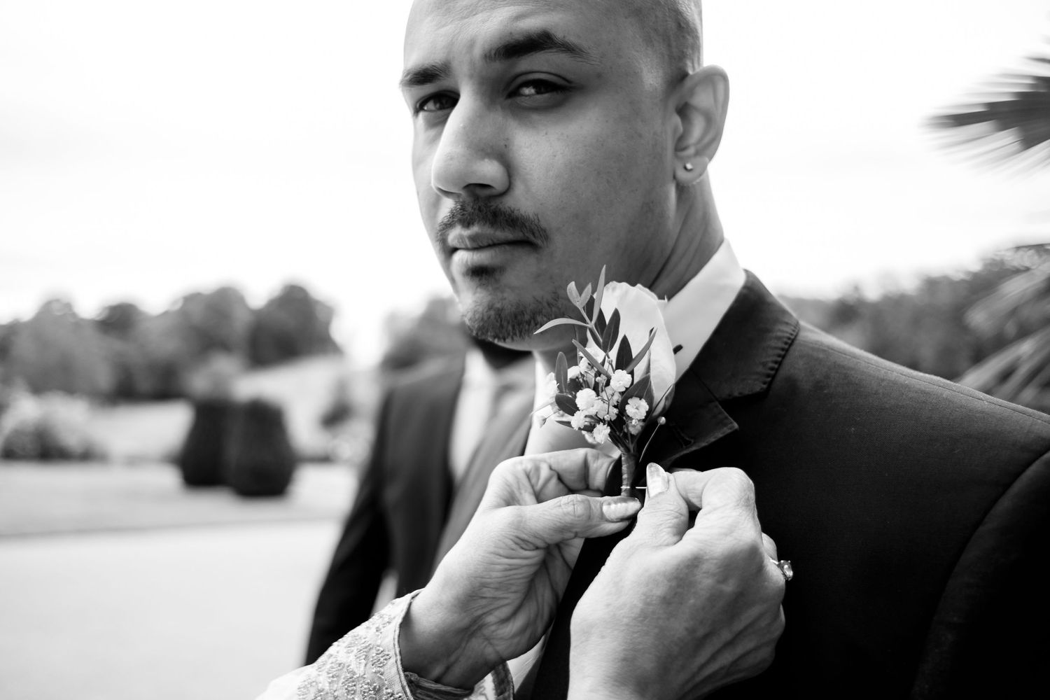 Groomsmen adjusting their ties and getting ready before the wedding ceremony.