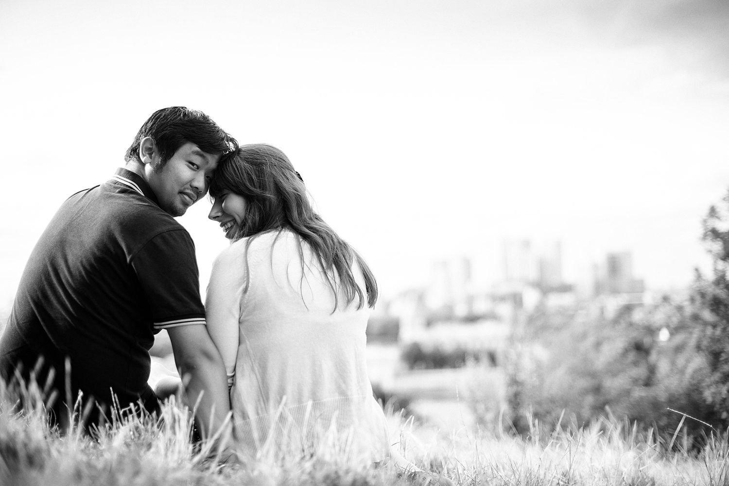 Intimate black and white portrait of a couple in soft focus.