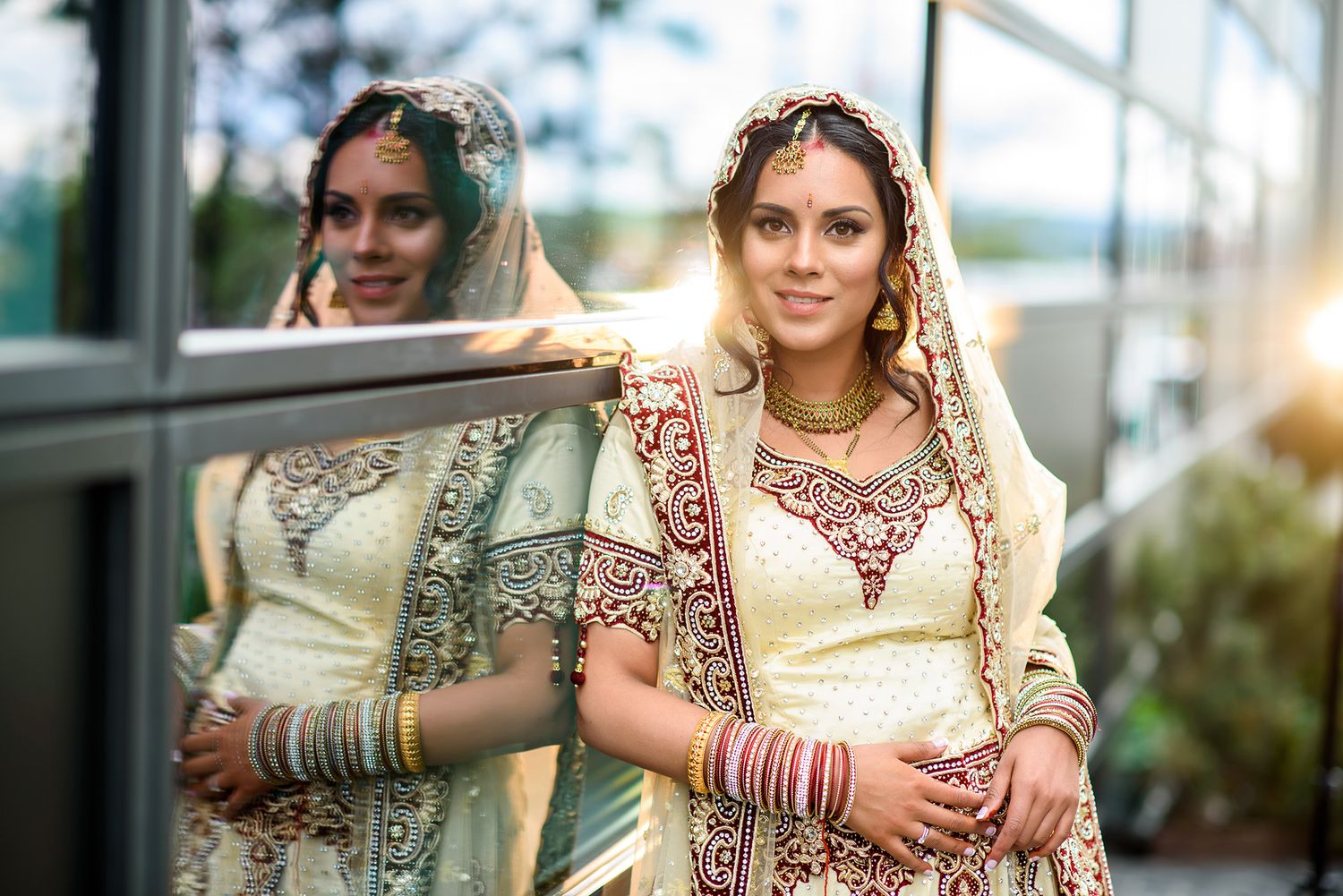 Beautiful bridal details at an Indian wedding with intricate embroidered attire and jewelry.